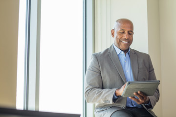 Mature African American man working on a tablet.