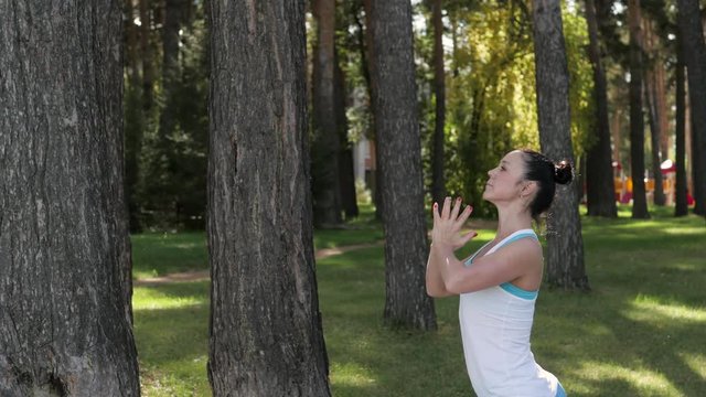 young woman doing yoga in the park in the open air. healthy lifestyle