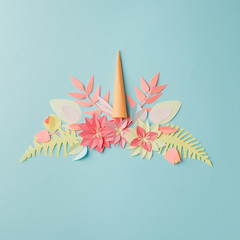 Colorful unicorn head from papercraft flowers. Paper art idea. Invitation or holiday card for Valentine's Day, birthday, easter, holiday, springtime and summer concept