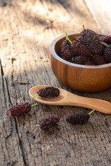 Fresh mulberry fruit on wood table background