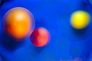 red and yellow and orange balls in blue water