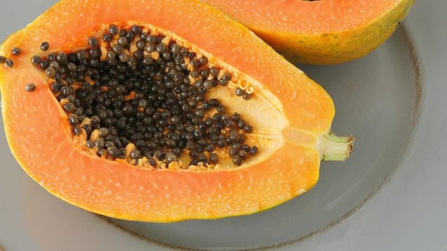 Top view of ripe half cut papaya, flat lay. Rotate