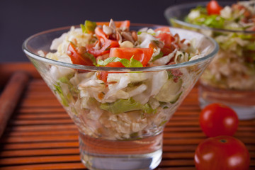 mixed vegetable salad with tomatoes, onions, cabbage, sprouts of grain in a bowls