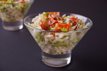 mixed vegetable salad with tomatoes, onions, cabbage, sprouts of grain in a bowls