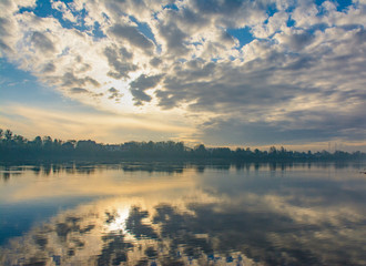 Spring foggy morning on the banks of the Neva river in Rybatskoye district in St. Petersburg.