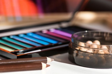 Top, up view of professional cosmetics, makeup background. Brushes, eye shadows, eyebrow pencils, powder, bronzing balls, mascara, red lipstick. Tools isolated on white. Concept of get ready for party