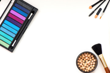 Top, up view of professional cosmetics, makeup background. Brushes, eye shadows, eyebrow pencils, powder, bronzing balls, mascara, red lipstick. Tools isolated on white. Concept of get ready for party