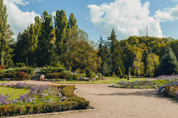 Beautiful view of green city park with flower beds