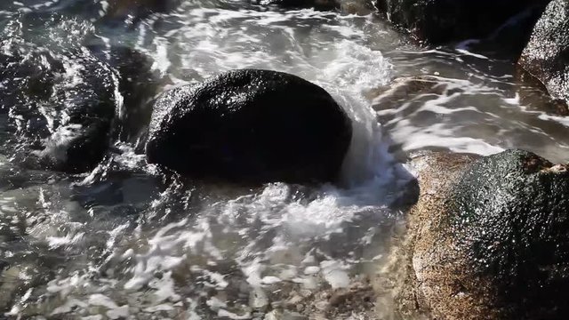 stormy weather on the sea, strong waves seethe and splash among the large coastal stones
