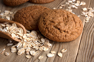 Oatmeal cookies with oat flakes with a wooden spoon. healthy food. on a wooden table