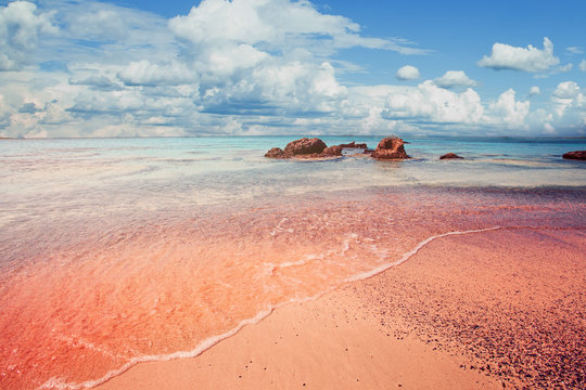 Beautiful Elafonissi beach on Crete, Greece. Pink sand, blue sea water and clouds sky