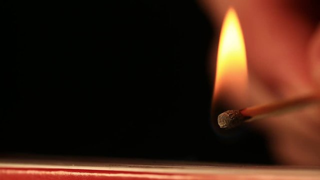 Striking and Igniting a Match Stick with Shallow Depth of Field.