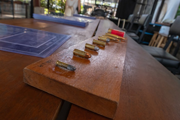 many size of bullets on the wooden board