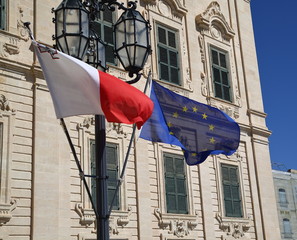 flags  of Malta and European Union in front of a building