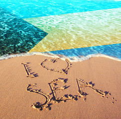 Beach sand, sea and flag Bahamas islands. I love Bahamas concept