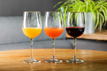 Fresh juice in a glass on a wooden table. The concept of healthy eating