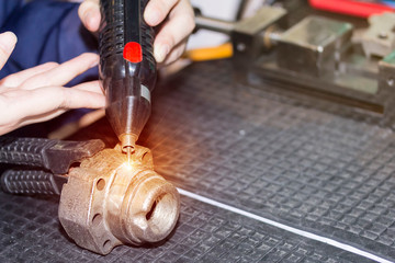 operator use electro spark engraving equipment for carbide metal micro coating or build up mass of...