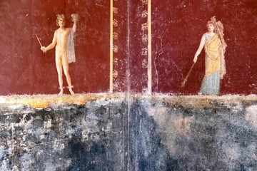 winged Amorino of the same Erote on a white wall
