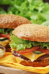 Two fresh hamburgers with vegetables