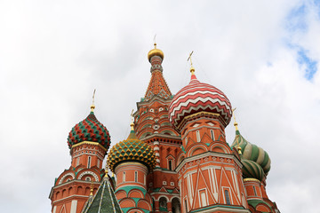 Fototapeta na wymiar St. Basil's Cathedral against the sky with white clouds. Russian architecture landmark, located on Red square in Moscow, symbol of Russia