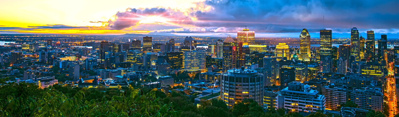 Fototapeta na wymiar Montreal city at sunrise in the beautiful morning. Amazing view from Mont-Royal with colorful blue buildings. Stunning panorama of Montreal downtown skyline in the fall morning.