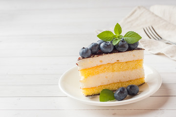 Cake of a souffle with glaze and fresh blueberries. copy space