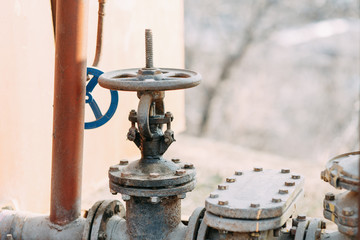 Fototapeta premium Gas taps and pipes in nature. Environmental problems and pollution.