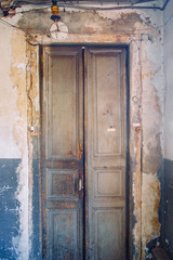 Facades of old rusty doors. Beautiful arches with greenery in the fortresses.