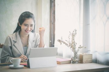 Confident happiness young woman working on laptop or notebook in her office.