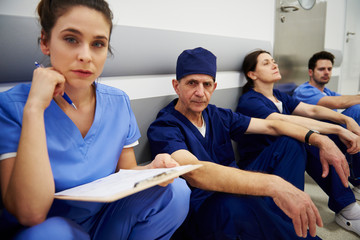 Group of tired surgeons after long day at work