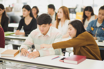 Seminar meeting room with many audiences for business concept, Professional education, work meeting, presentation or coaching, focus on young Asian men and woman which discussion.