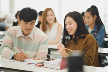 Seminar meeting room with many audiences for business concept, Professional education, work meeting, presentation or coaching, focus on young Asian men and woman which discussion and writing a book