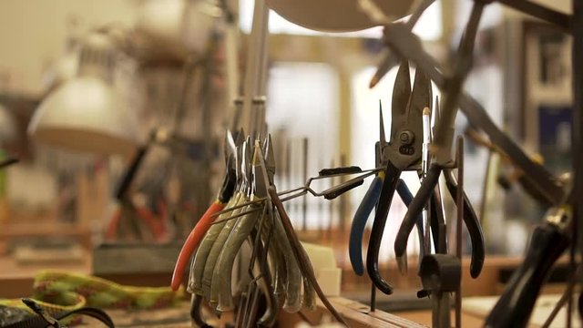 Close-up of workroom full of pliers, tweezers, splitters and other tools
