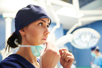 Female surgeon preparing for the operation