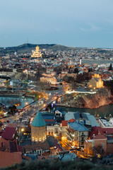 Fototapeta premium Sunset and evening city Tbilisi, Georgia. Panoramic views and lights of historic neighborhoods.