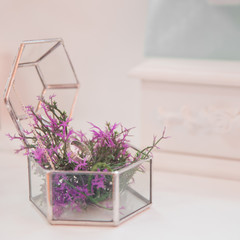 Wedding ring in Glass box with flowers inside. Abstract geometric shape of glass. Concept of design wedding.