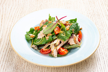 Mix salad with chicken and tomatoes. On light background