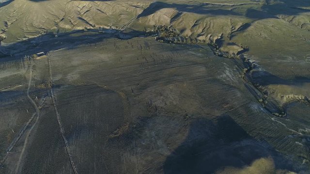 Valley of green farming fields and hills frome above. Shot. Aerial view.