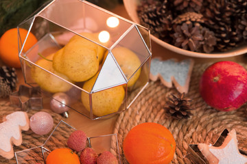 Christmas table setting with glass objects with fruit. Cozy home interior decor. Abstract geometric shape of glass.