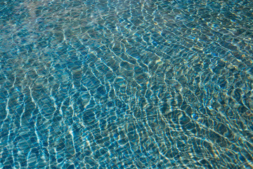 The texture of the water in the summer pool close-up