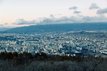 Sunset and evening city Tbilisi, Georgia. Panoramic views and lights of historic neighborhoods.