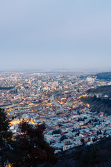 Sunset and evening city Tbilisi, Georgia. Panoramic views and lights of historic neighborhoods.