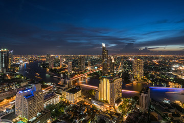 Fototapeta premium Landscape of Chao phraya river in Bangkok city in evening time with bird view. Bangkok City at night time, Hotel and resident area in the capital of Thailand.