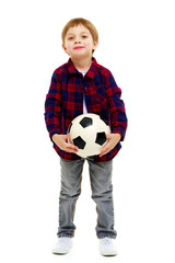 Little boy is playing with a soccer ball.