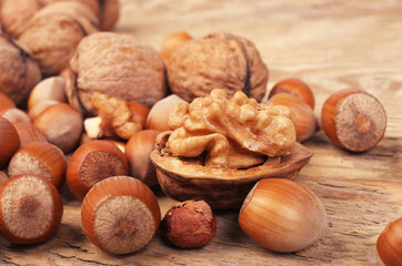 Walnuts and hazelnuts on a wooden table