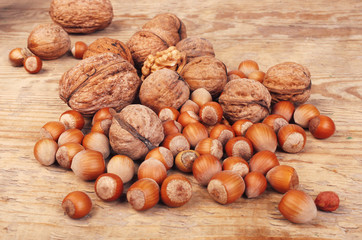 Walnuts and hazelnuts on a wooden table