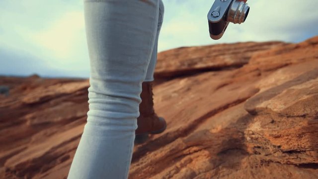 Photographer with retro camera at the canyon 