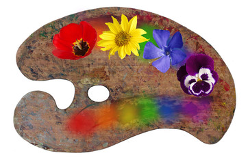 Art palette with rainbow spots and flowers. A symbol of art. Isolated on white