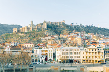 Fototapeta premium Dawn in the old city of Tbilisi, Georgia. Panoramas of the ancient city and the fortress.