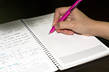 hand with pen signing a document
